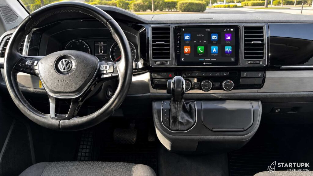 Vw T6 Dashboard With Upgraded 9-Inch Touchscreen Radio, Modern Infotainment Display And Original Volkswagen Steering Wheel.